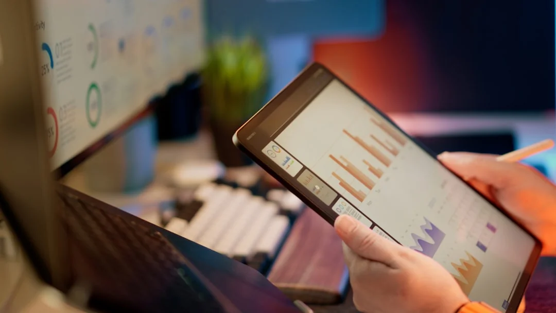 Hands discussing marketing strategy with charts in an office setting.