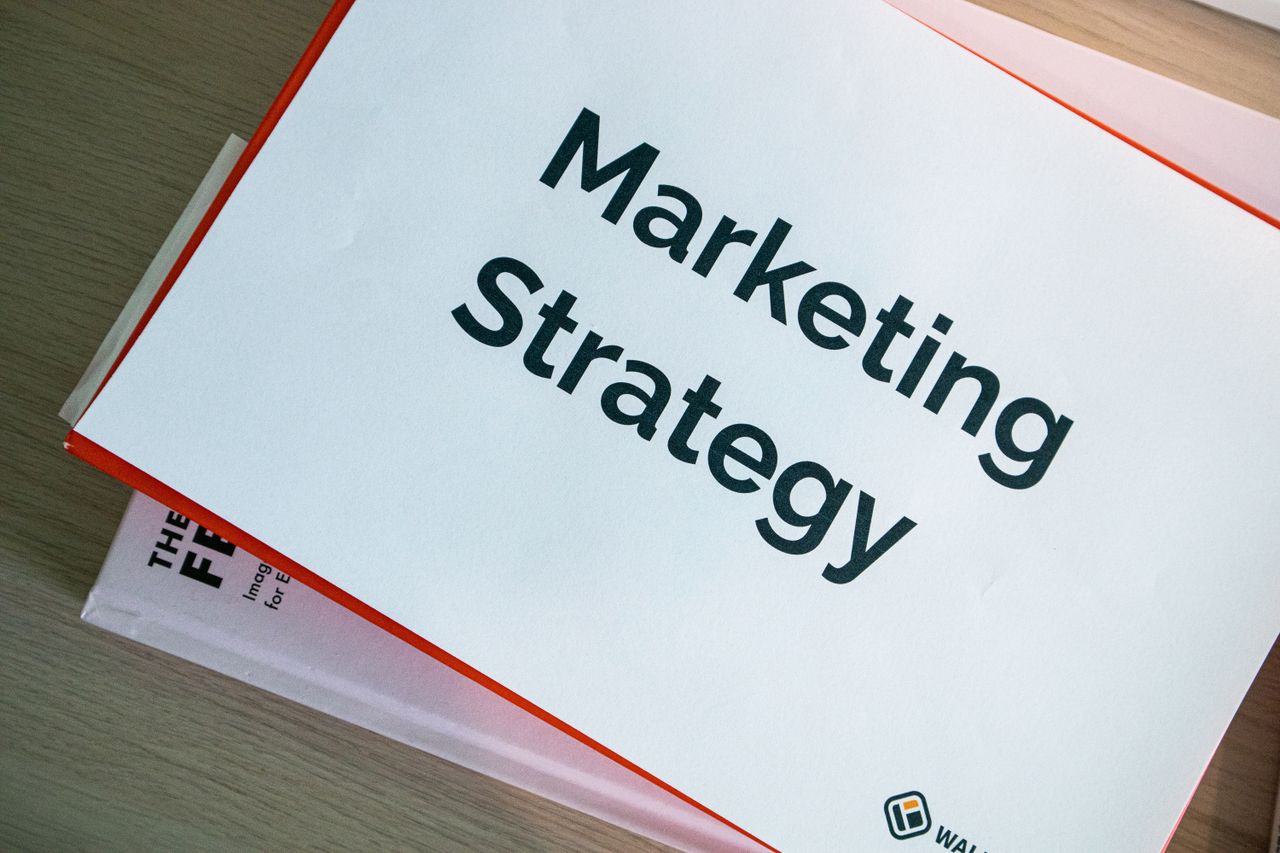 digital A marketing strategy document displayed on a desk, showcasing business planning essentials.